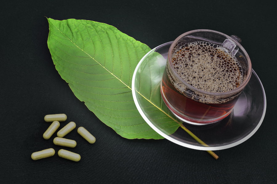 a cup of tea and capsules on black background